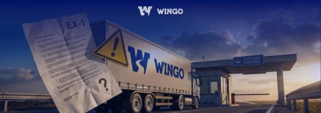 Вантажівка Wingo з документом EX-1 та попереджувальним знаком на фоні дороги